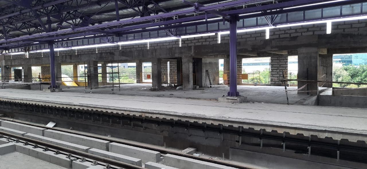Elevated platform level under a steel roof during flooring works.