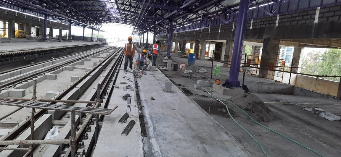 Workers on the platform level beside the track area.