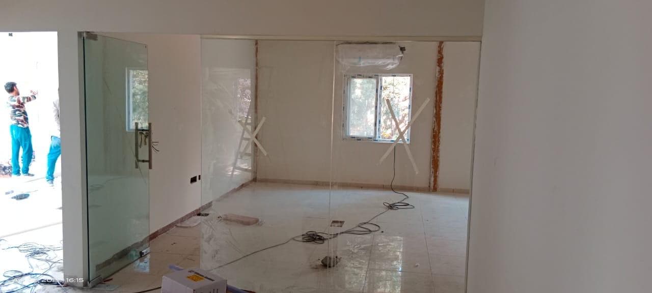 Glazed partitions and a glass door in a finished office.