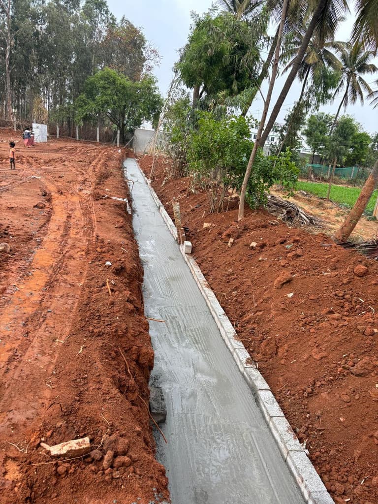 Base of the retaining wall with excavated soil alongside.