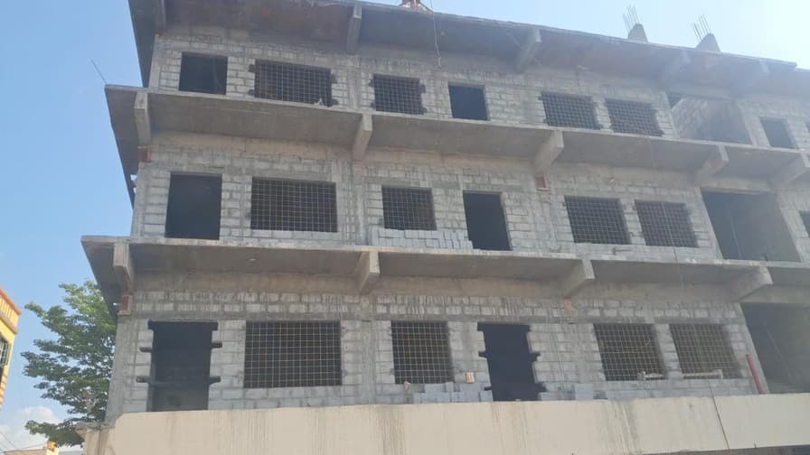 School building elevation showing block masonry on each floor.