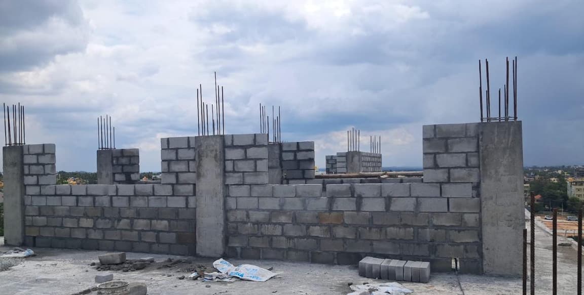 Block walls rising between concrete columns at roof level.