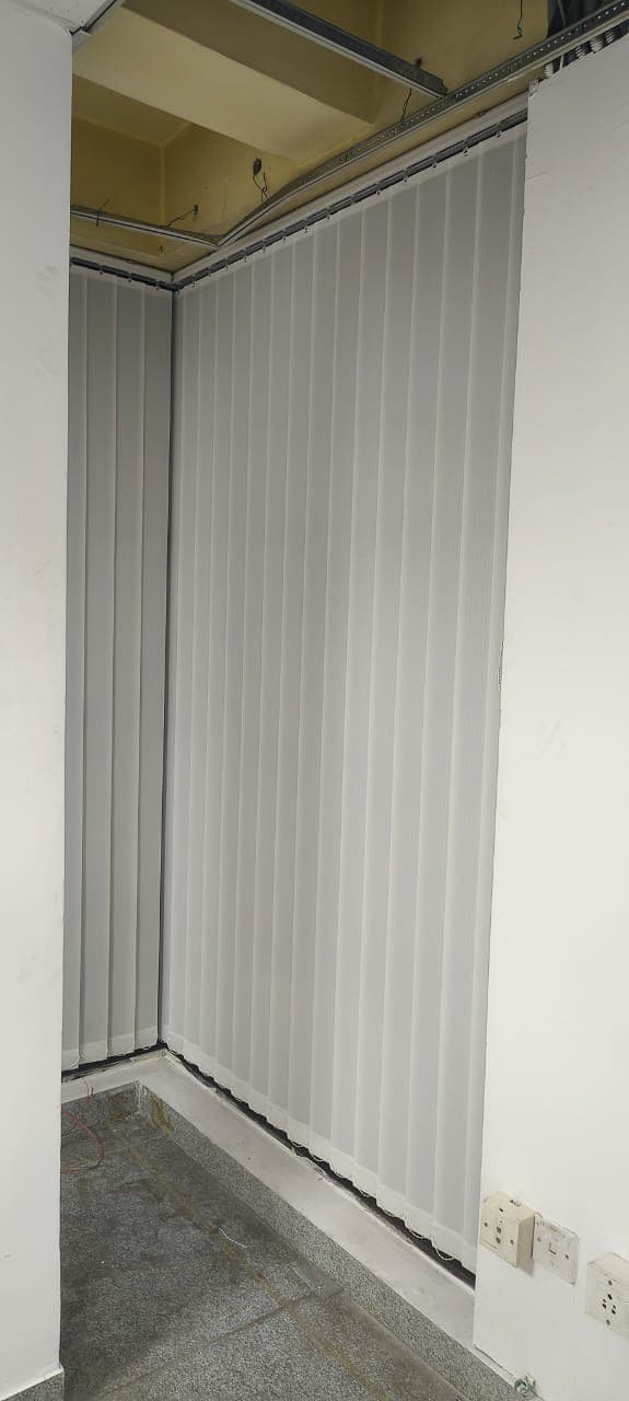 Panelled partition at the edge of an office room.