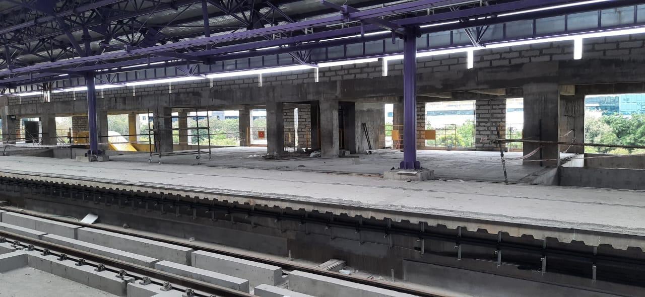 Elevated platform level under a steel roof during flooring works.