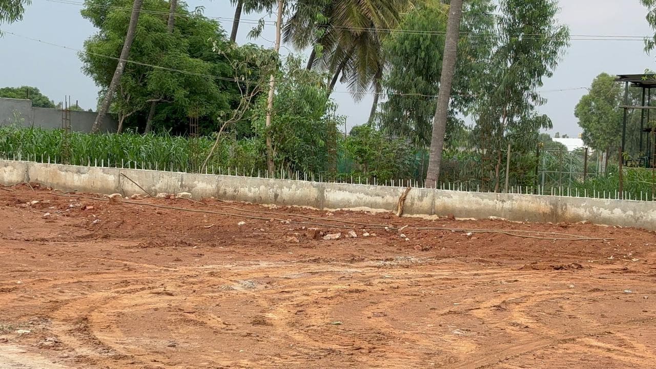 Retaining wall running along the edge of a cleared site.