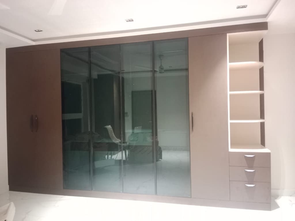 Full-height wardrobe with glass shutters and open shelves.